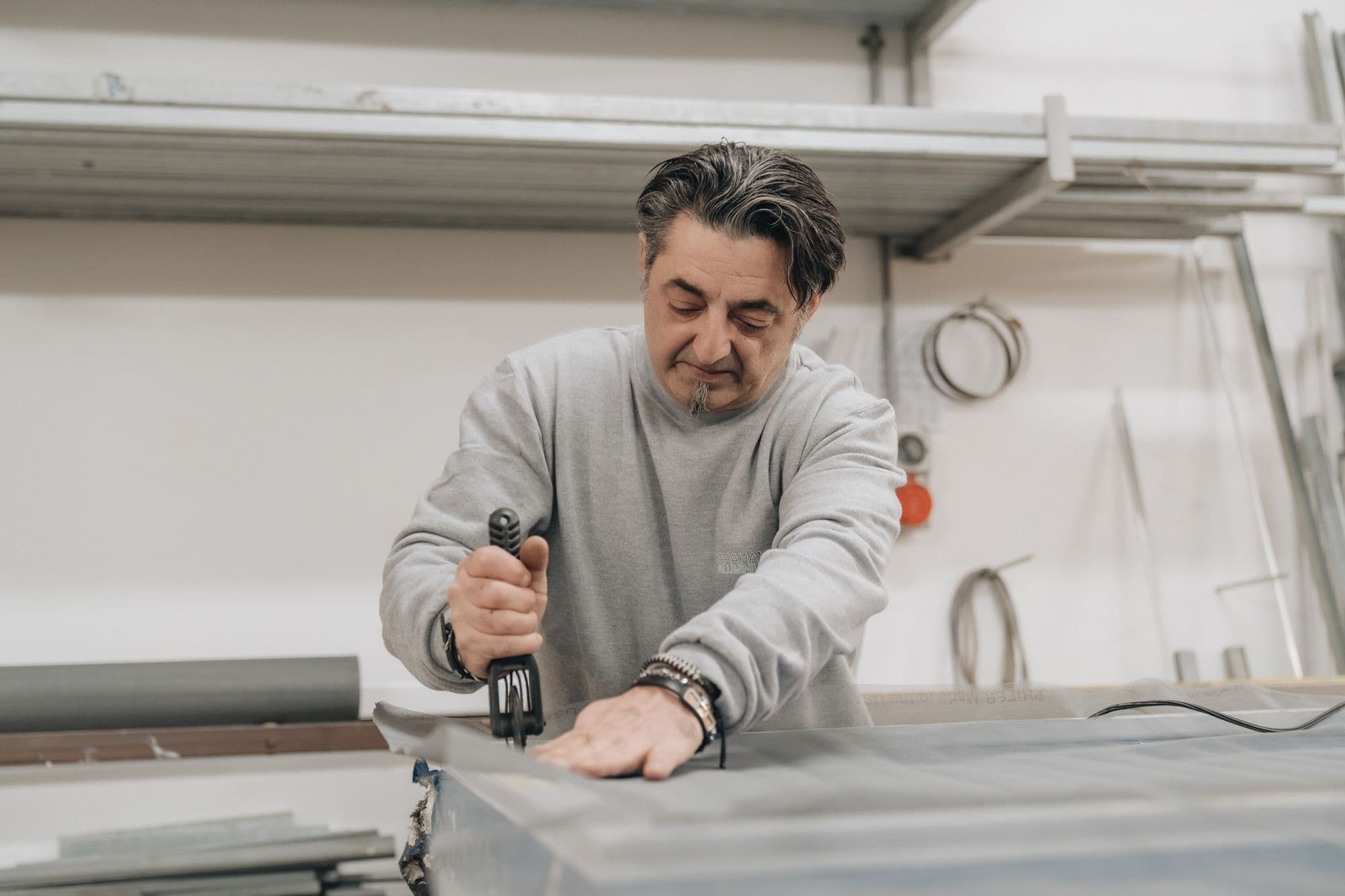 Graham Aluminium craftsman working on an aluminium profile in the workshop