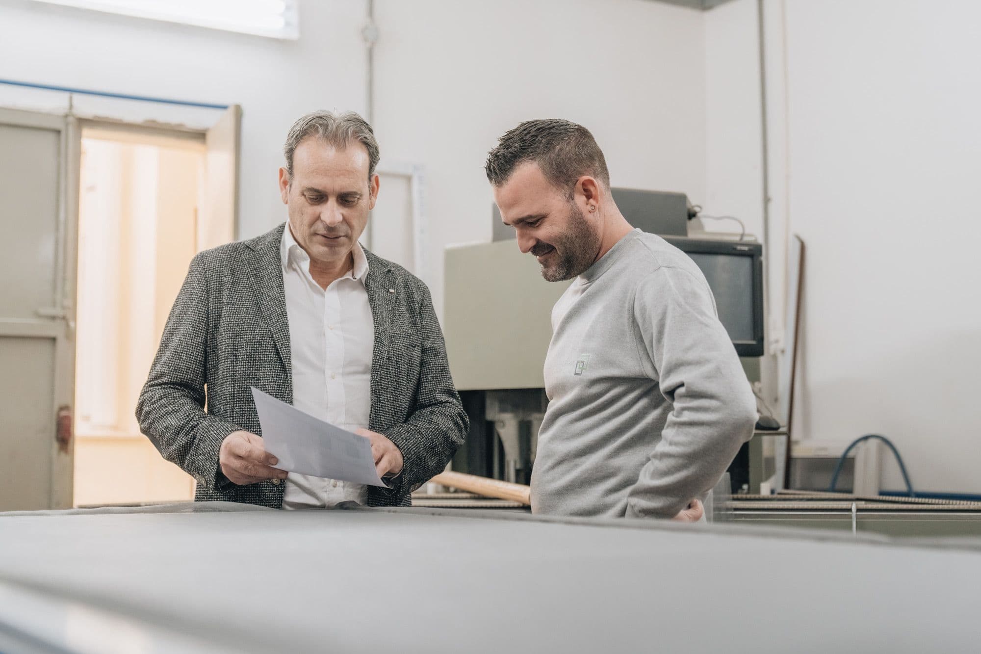Two members of the Graham Aluminium team going over a drawing in the workshop