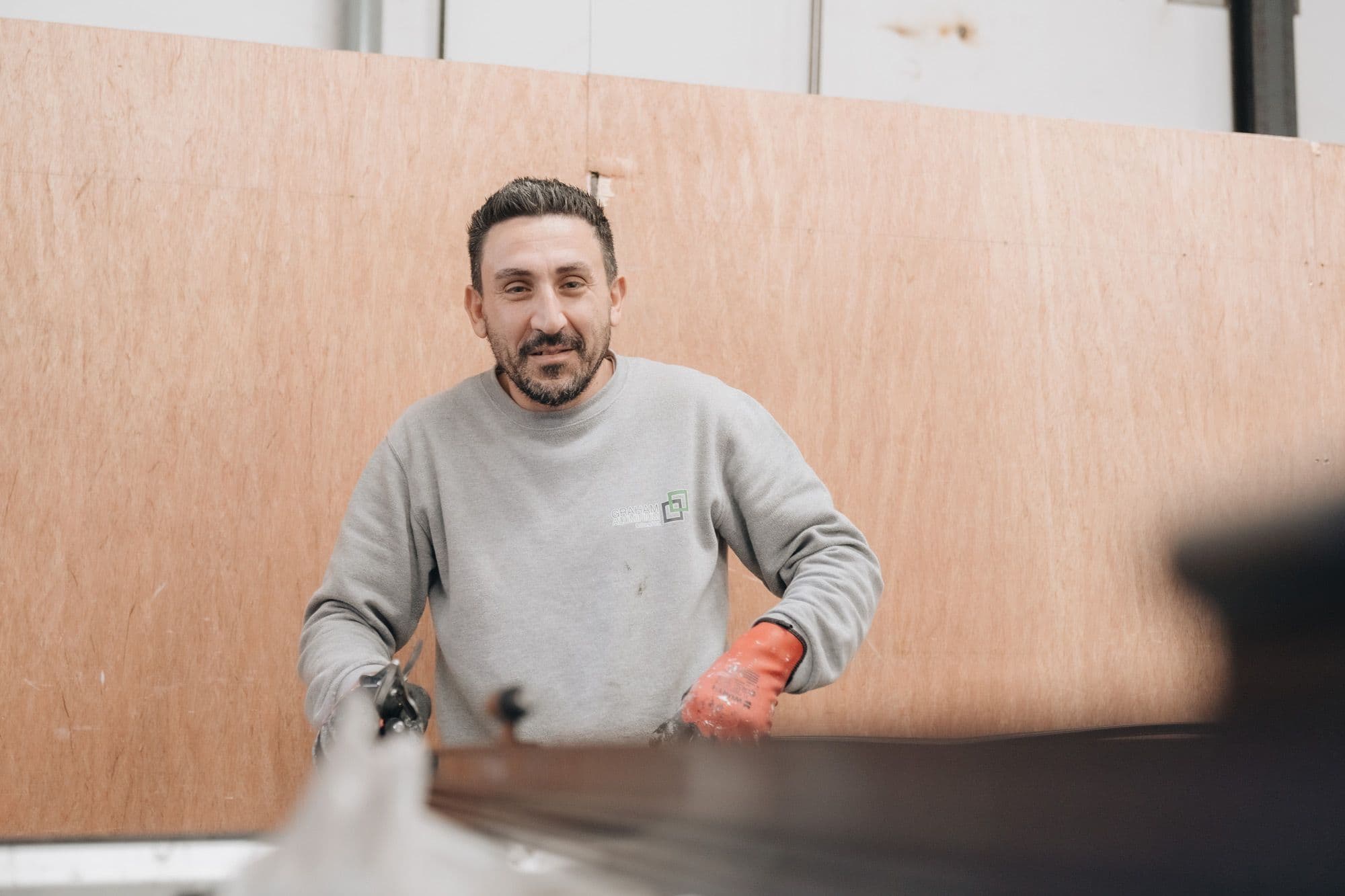 Graham Aluminium team member at work, wearing work gloves